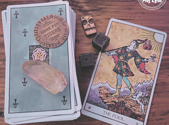 The Fool tarot card on a wooden desk